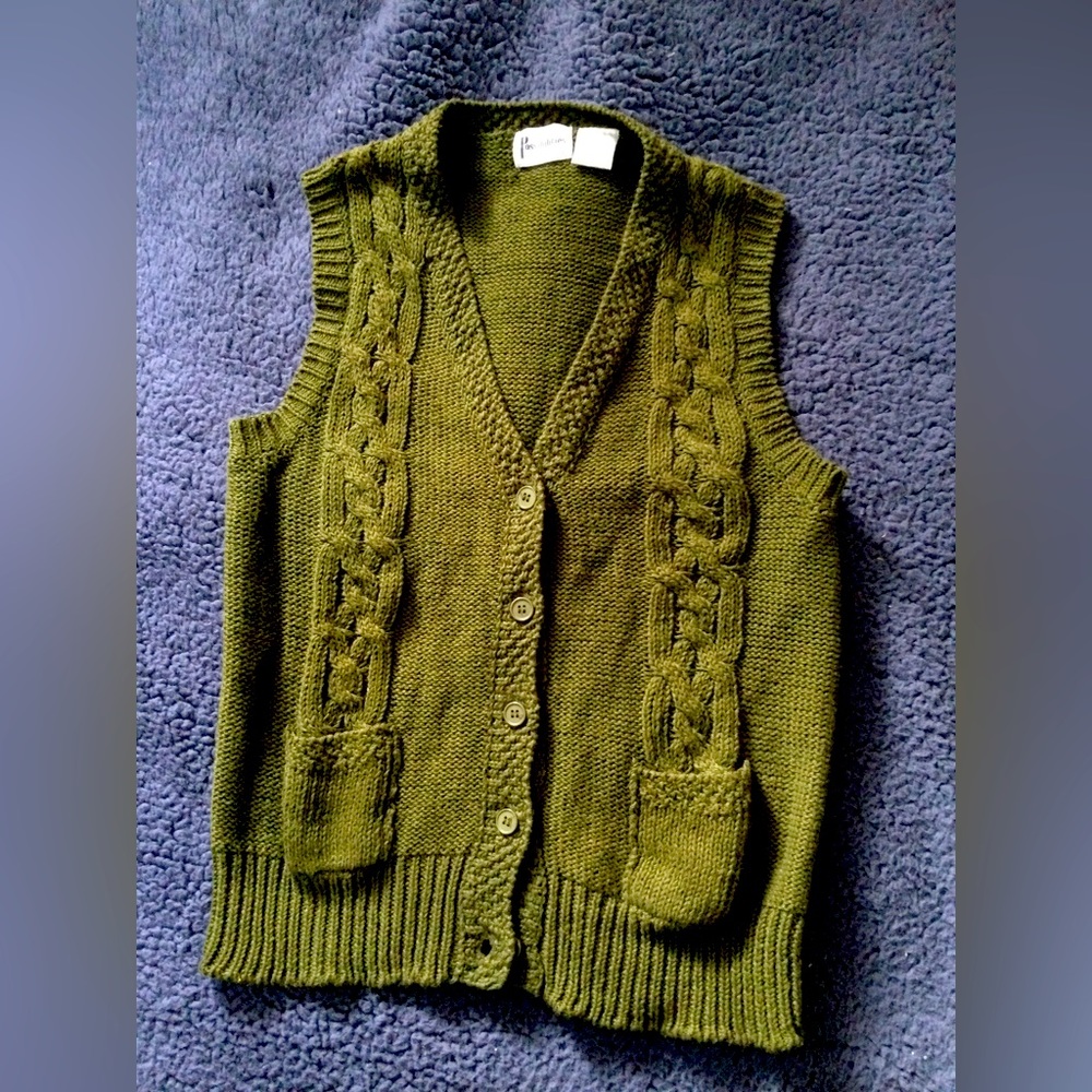 Woman’s stylish knit button down sweater vest with front pockets.